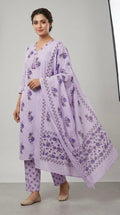 Woman wearing a light purple traditional outfit with floral patterns on a gray background