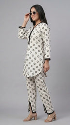 Woman wearing a patterned outfit on a gray background
