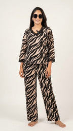 Woman wearing a zebra print pajama set on a white background