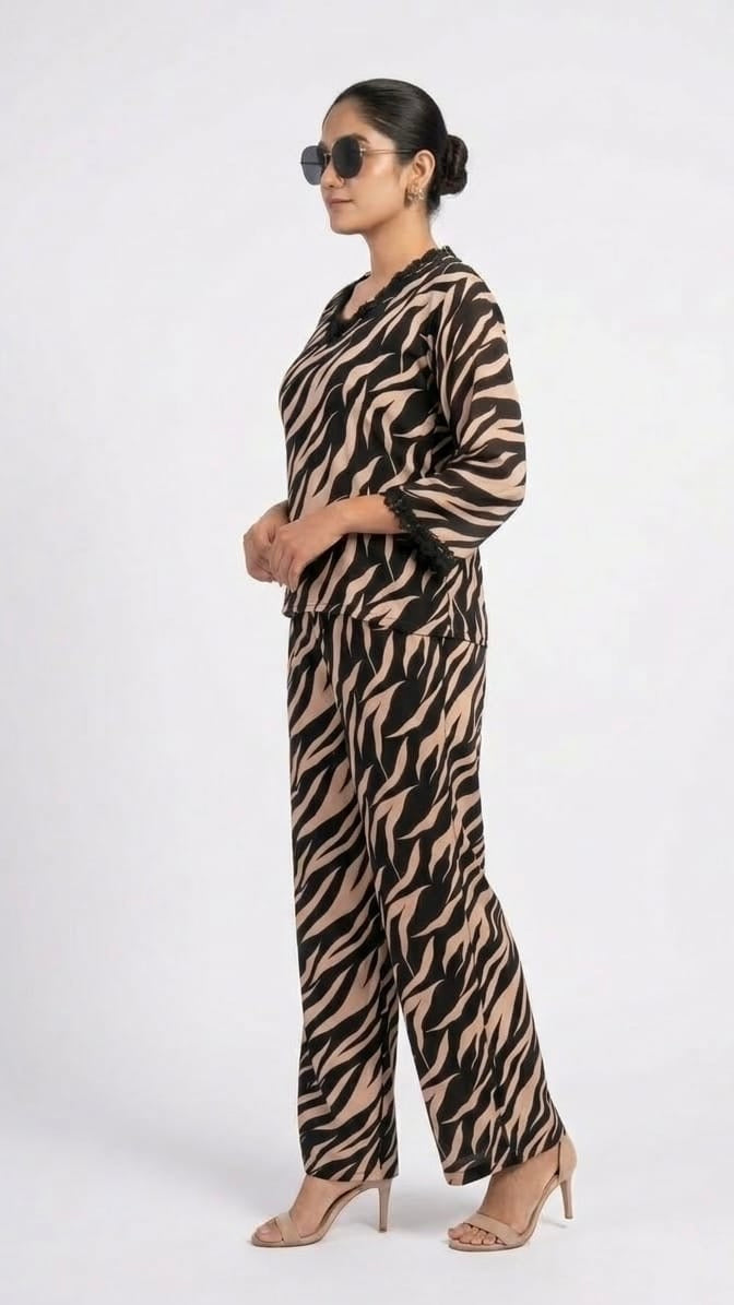 Woman wearing a zebra print jumpsuit on a white background