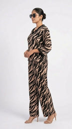 Woman wearing a zebra print jumpsuit on a white background