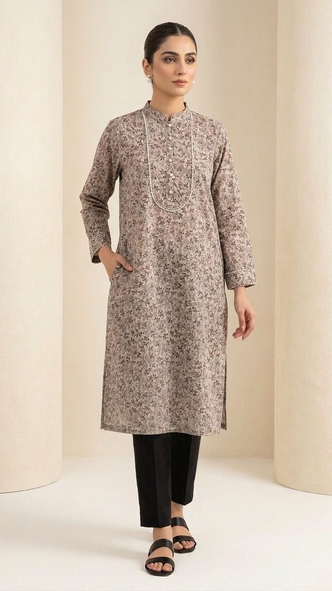 Woman wearing a patterned kurta with black pants against a plain background