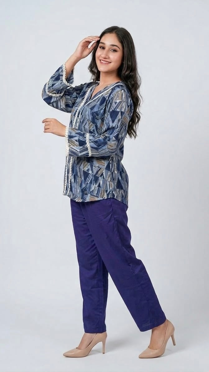 Woman wearing a blue patterned top and purple pants on a white background
