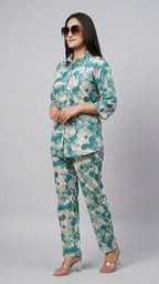 Woman wearing a floral outfit on a gray background