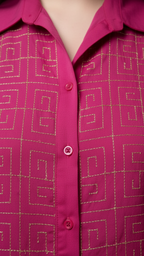 Close-up of a pink shirt with gold geometric pattern