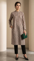 Woman wearing a patterned kurta with black pants against a neutral background