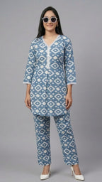 Woman wearing a blue and white patterned kurta with matching pants on a gray background